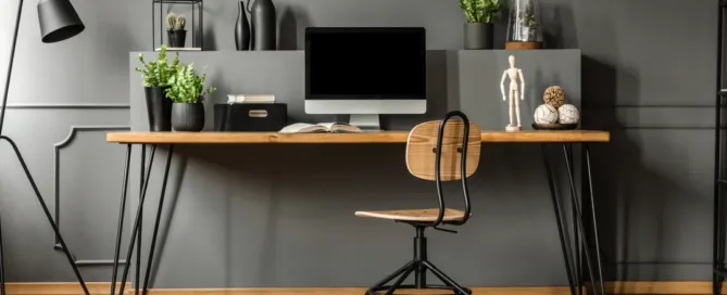A desk with a computer and an office chair, arranged for work or study.