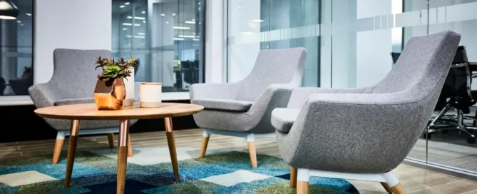 Two office chairs and a small table arranged together in a professional workspace setting.