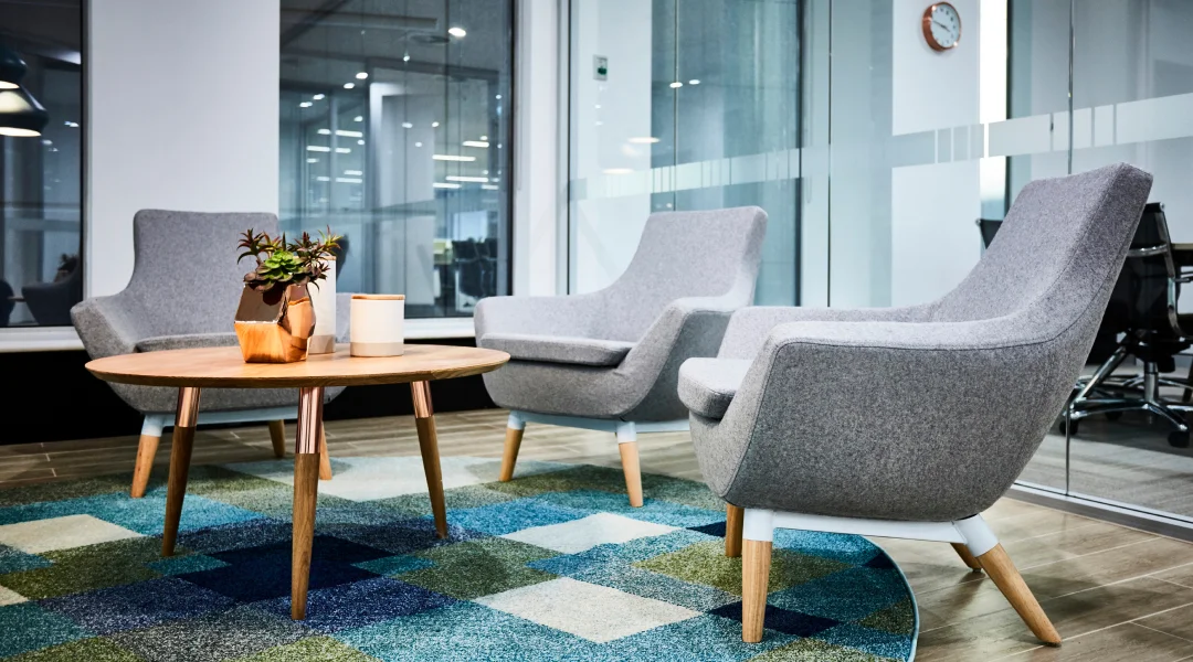 Deux chaises et une table dans un bureau, créant un espace de travail fonctionnel et accueillant.